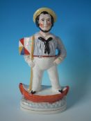 Staffordshire Pottery sailor in boat with flag figure