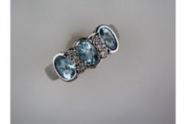 An Unused 3 Stone Aquamarine and Diamond Ring