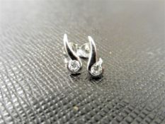 0.20ct diamond swirl style earrings set in platinum 950. 2 small brilliant cut diamonds, H/I