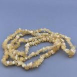 A long 35" string necklace of yellow / white / lemon quartz natural gemstones