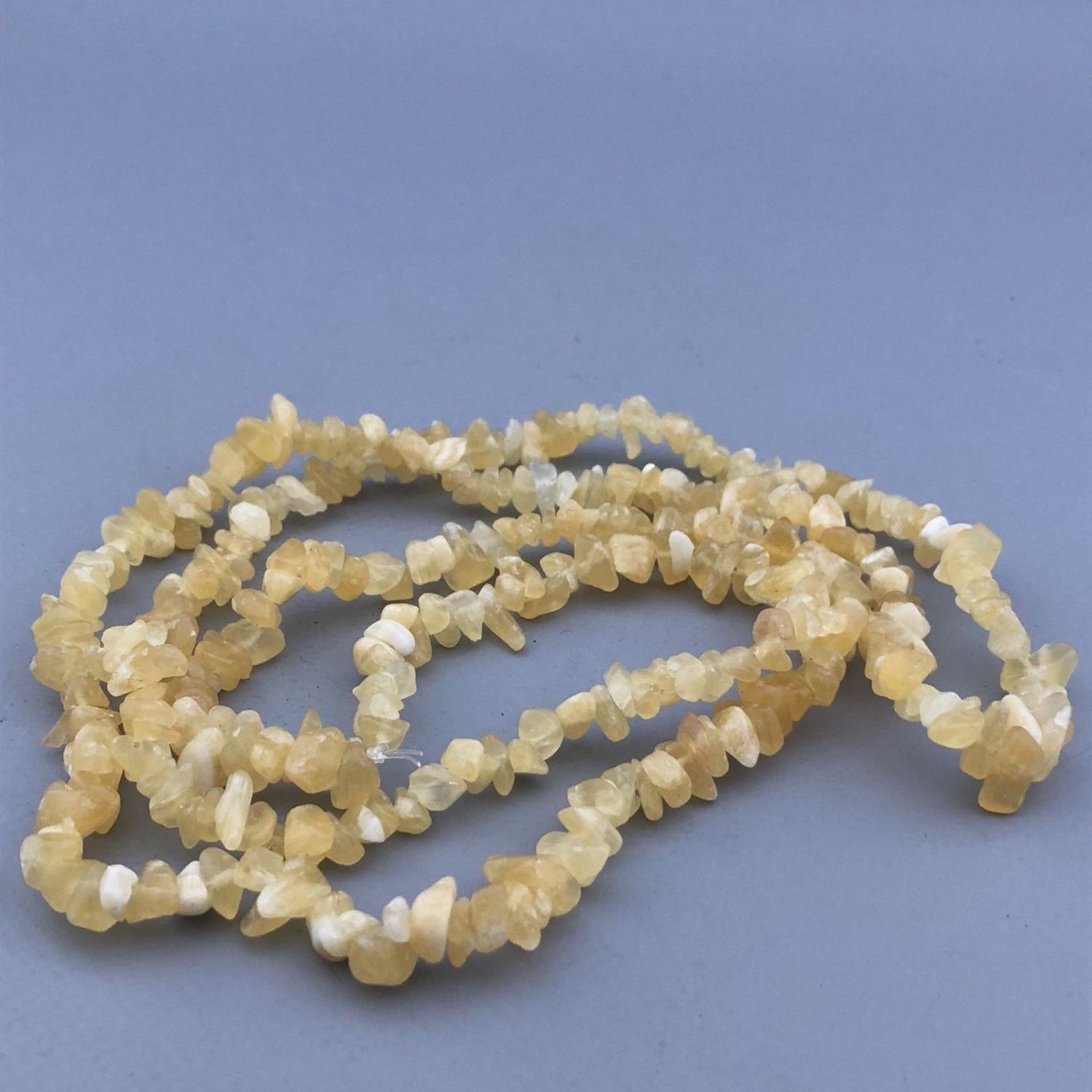 A long 35" string necklace of yellow / white / lemon quartz natural gemstones