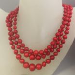 An original vintage 1950s necklace triple strand of bright red graduated beads