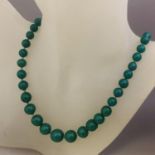 A vintage necklace of carved natural Imperial dark Green Jade graduated beads