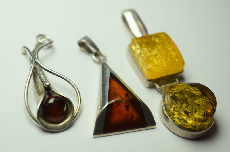 Three Silver And Amber Pendants