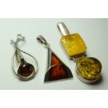 Three Silver And Amber Pendants