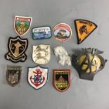 A Collection of vintage cloth patches and an AA car badge.