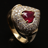 Heart-shaped ruby surrounded by white brilliant cut diamonds