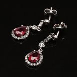 Earring with Drops of red ruby, surrounded by white stones