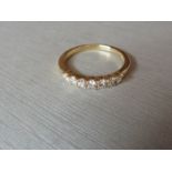 0.42ct diamond band ring set in 9ct yellow gold. 7 Small brilliant cut diamonds, I colour and i1