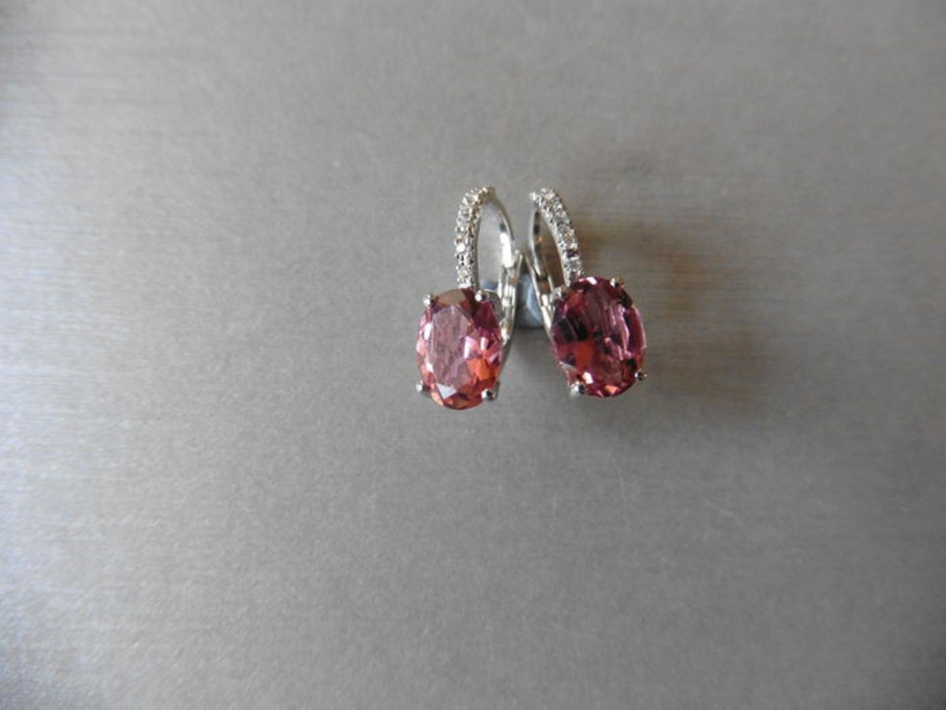18ct white gold tourmaline and diamond hoop style earrings. 2 oval cut tourmalines, 1.60ct total