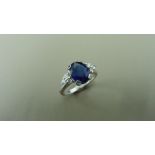 2.50ct sapphire and diamond dress ring. 9x7 oval cut ( glass filled ) with 3 small brilliant cut