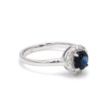 A Graceful Round Cut Blue Sapphire Halo Ring in 18K White Gold