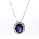 An Oval Shaped Sapphire and Diamond Drop Pendant in Claw Setting