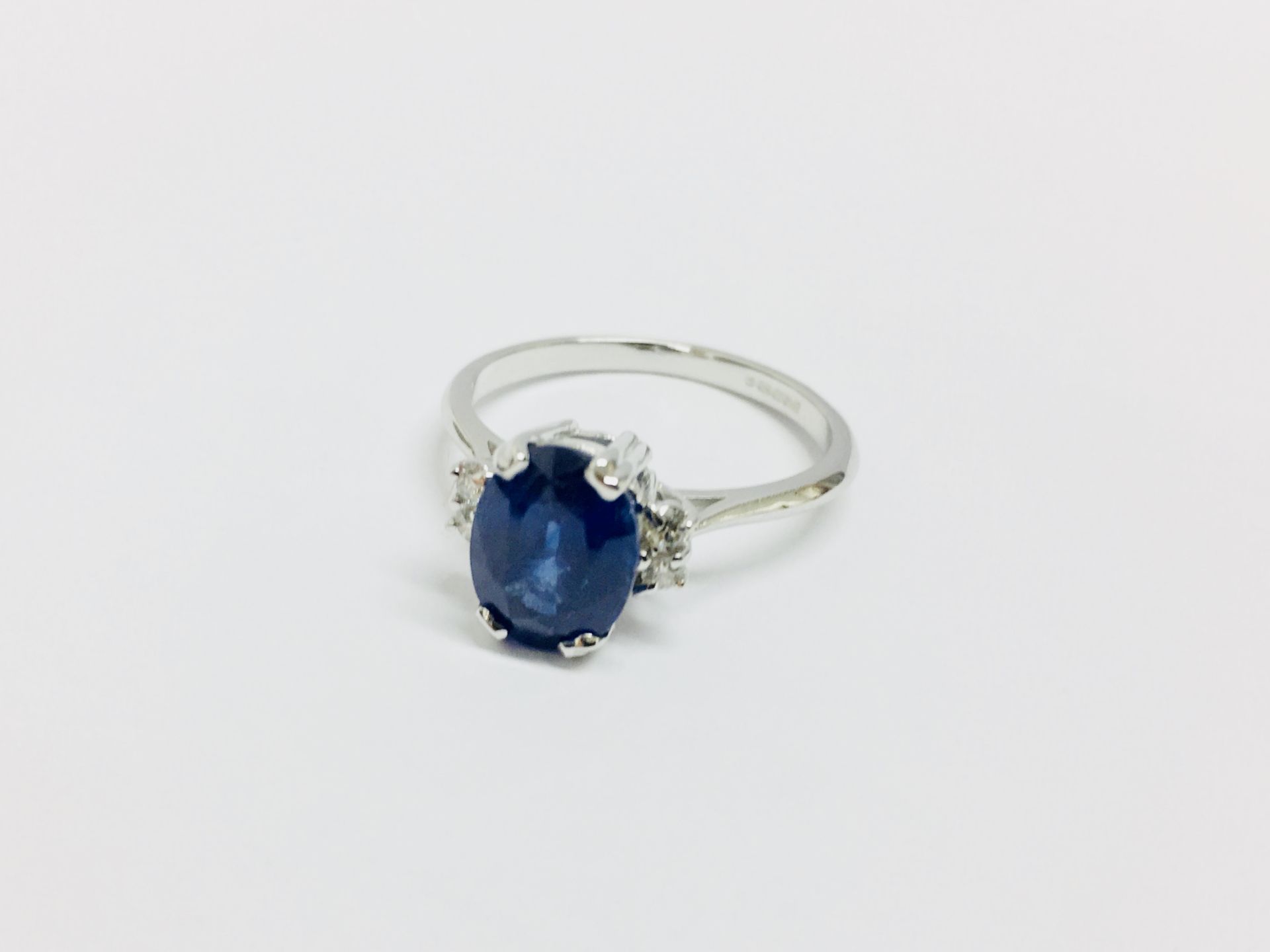 2.40ct sapphire and diamond ring. Oval cut ( glass filled ) sapphire with 2 small brilliant cut