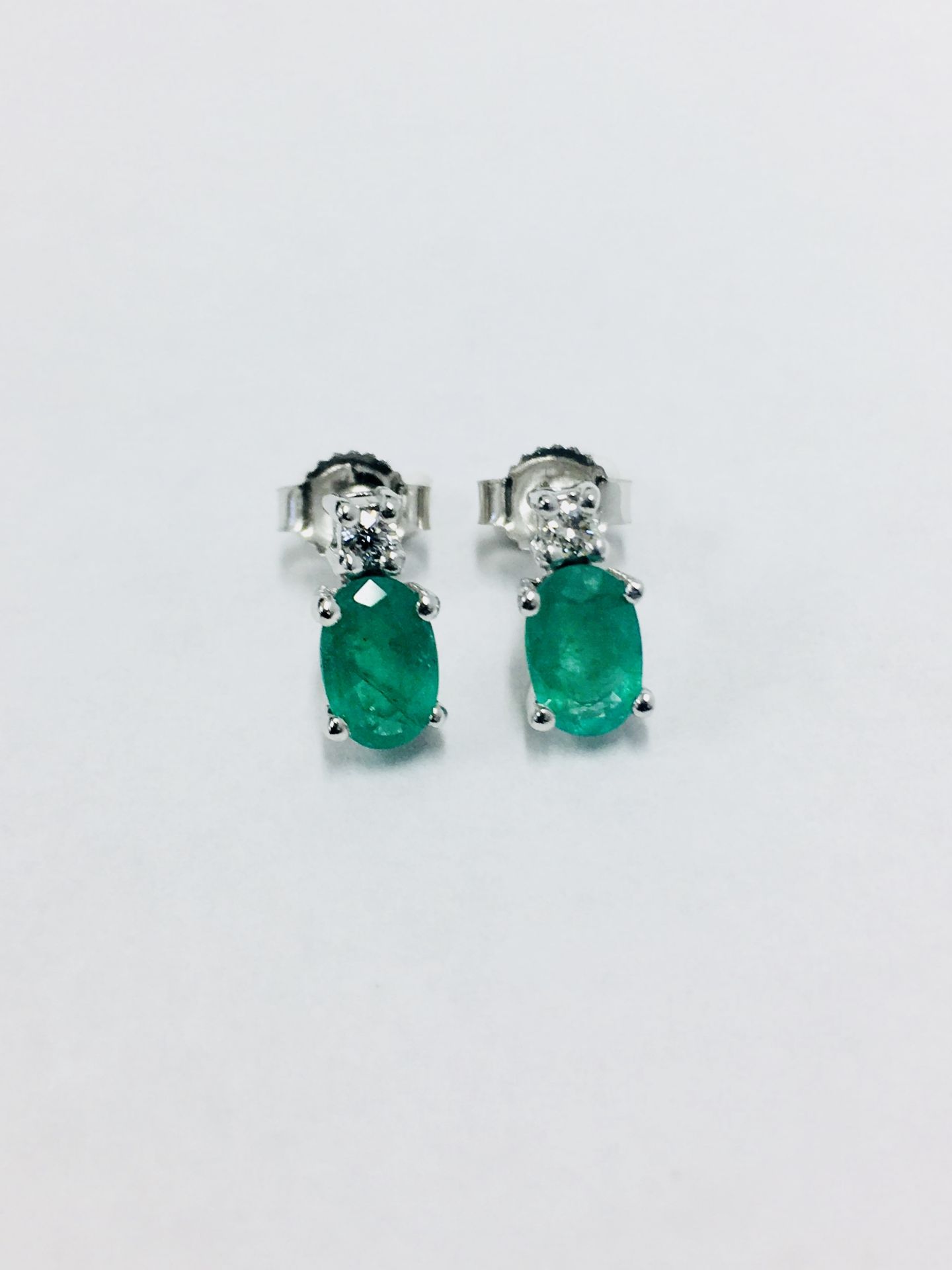 Emerald and Diamond drop earrings. Each set with a 7 x 5mm oval cut emerald ( treated), 1.60ct