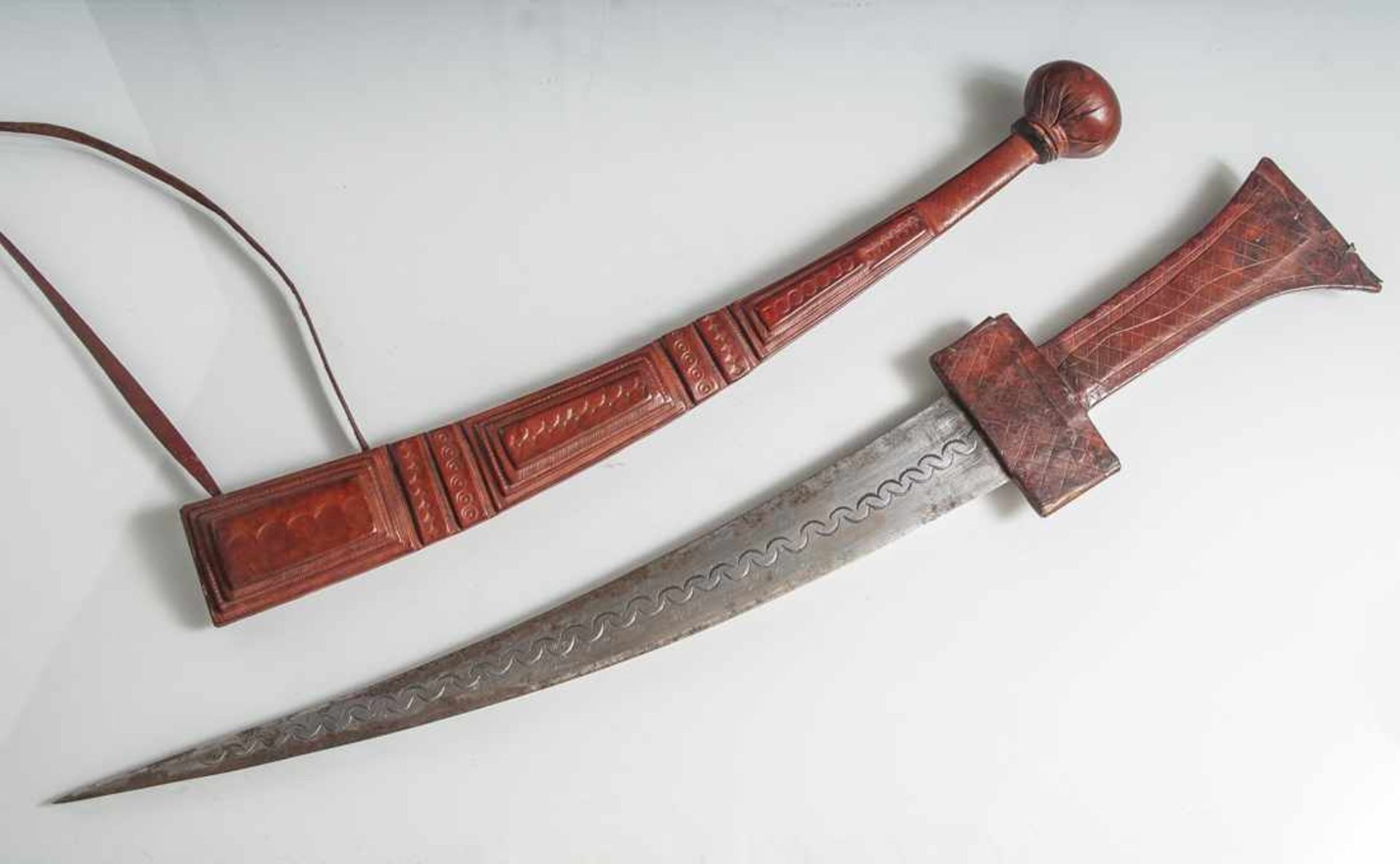 Kurzschwert, wohl Afrika, Griff und Scheide aus geprägtem Leder, L. ca. 60 cm.