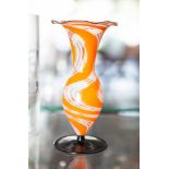 Kleine Vase, farbloses Glas, runder opak schwarzer Fuß, Korpus mit orange-weißerEinschmelzung,