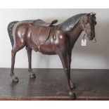 Figurine, naturalistisch gearbeitetes stehendes Pferd mit Zaumzeug und Sattel, wohl um1900, Korpus