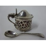 A hallmarked silver mustard pot and glass liner, together with a salt spoon.