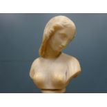 A carved alabaster bust of nude girl