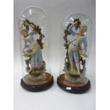 Pair of French bisque figurines under glass domes