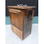 A early 20th century oak counter display cabinet, the glazed front door enclosing two shelves