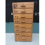 An Edwardian oak eight drawer filing cabinet, with metal label slots.