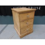 A mid 20th century pine bedside chest of three drawers with lobed glass handles