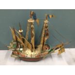 A vintage wooden model of a galleon ship