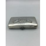 A Russian silver cigarette case with rifle emblem to front