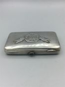 A Russian silver cigarette case with rifle emblem to front