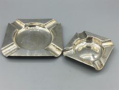 Two square silver ashtrays