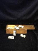 A boxed set of bone and ebony vintage dominoes