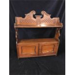 A mahaogany wall shelf with cupboard