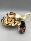 A Crown Derby tea cup, saucer and jug (AF)