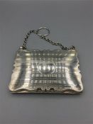 A Ladies Chatalaine purse 41/8" x 3" on short silver chain, striped, cartouche centre, containing