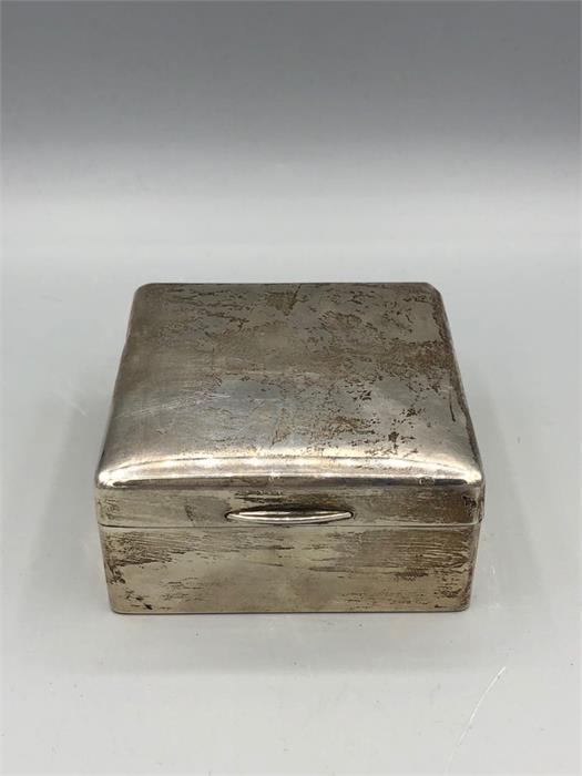 A silver cigarette box hallmarked London 1921-22