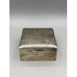 A silver cigarette box hallmarked London 1921-22