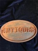 A Cast Iron Antiques Sign