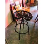 A Black tractor seat stool