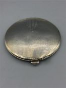 A silver powder compact 31/2" diameter, engine turned with some plain work on lid, marked b & Co