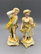 A pair of hand painted figures, possibly Staffordshire or Derby porcelain.