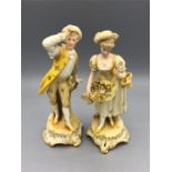 A pair of hand painted figures, possibly Staffordshire or Derby porcelain.