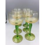 A set of six vintage green stemmed wine glasses