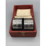 A pair of boxed napkin rings, engine turned, stamped plate