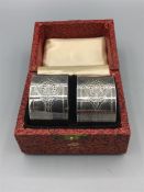 A pair of boxed napkin rings, engine turned, stamped plate