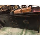 A long black Chinese style sideboard