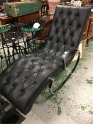 A black recliner with chrome arms