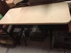 A cast iron Singer sewing table that has been converted to a table