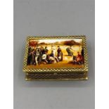 An 18ct gold plated on silver pill box with enamel image of Ladies playing tennis